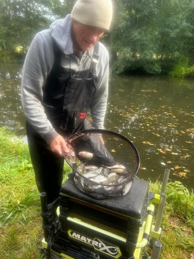 Andy Donegan with his net of fish